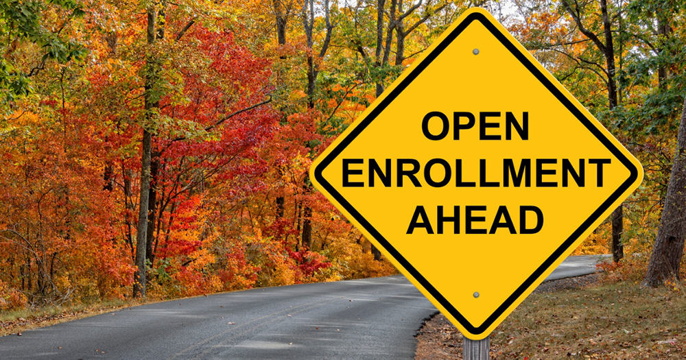 Road sign that says: Open Enrollment Ahead. The sign is in reference to the healthcare open enrollment period (OEP).